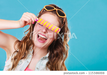 Summer woman eating popsicle ice pop cream Summer woman eating popsicle ice pop cream 115386008