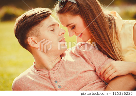 Affectionate couple on grass. 115386225