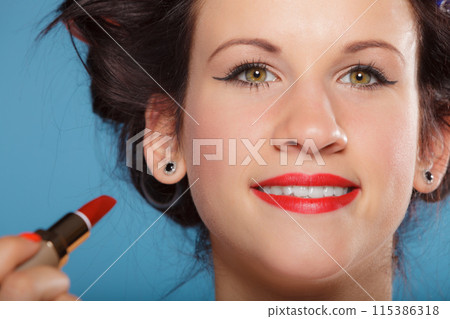 Part of face. Woman applying red lipstick Part of face. Woman applying red lipstick 115386318