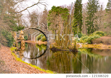 Rakotz Bridge gracefully arches over calm waters, mirrored perfectly against a backdrop of fall foliage. Germany Rakotz Bridge gracefully arches over calm waters, mirrored perfectly against a backdrop of fall foliage. Germany 115386320