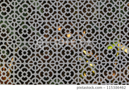 Close-up of a white chair with a floral pattern on the back. 115386462