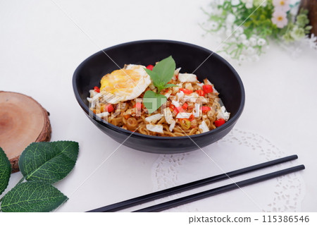 fried noodles with fried egg and vegetables as a background fried noodles with fried egg and vegetables as a background 115386546