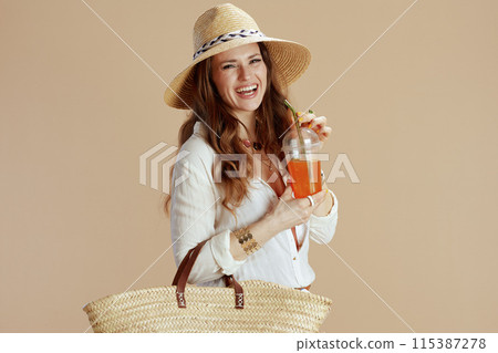 smiling trendy woman in blouse and shorts isolated on beige smiling trendy woman in blouse and shorts isolated on beige 115387278