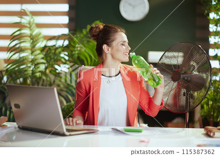 happy modern small business owner woman at work in red jacket 115387362