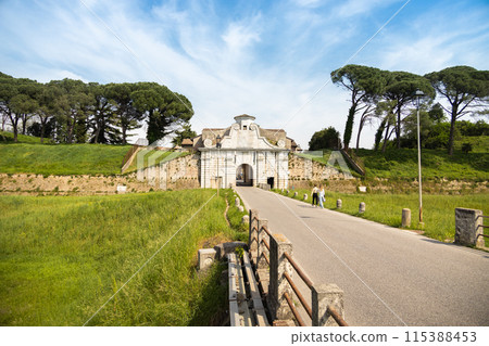 Palmanova, Italy, Europe - people walking on asphalt road to ancient town gate 115388453