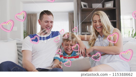 Image of hearts over happy caucasian family using tablet on sofa Image of hearts over happy caucasian family using tablet on sofa 115388662