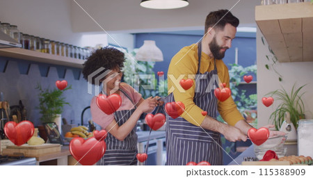Image of hearts ove diverse couple preparing meal in kitchen Image of hearts ove diverse couple preparing meal in kitchen 115388909