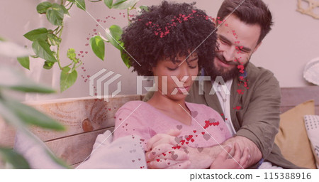 Image of hearts over happy diverse couple hugging Image of hearts over happy diverse couple hugging 115388916