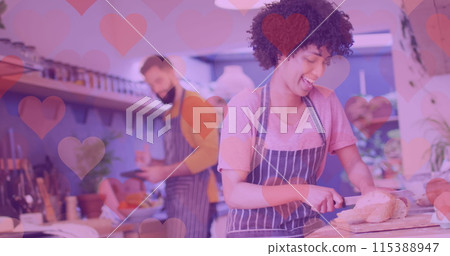 Image of hearts over happy diverse couple preparing meal 115388947