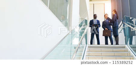 Group of multinational business people having a conversation in a lobby 115389252