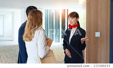 Female staff serving foreign guests at the reception Female staff serving foreign guests at the reception 115389255