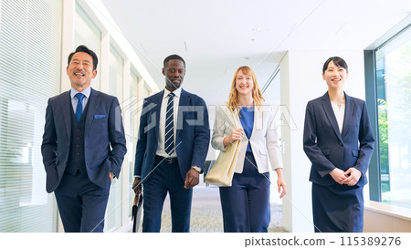 Group of multinational business people walking through a building and talking 115389276