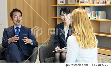 A group of multinational business people having a conversation in a lobby through an interpreter A group of multinational business people having a conversation in a lobby through an interpreter 115389277