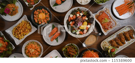 Top view of various traditional Japanese food dishes on wooden table Top view of various traditional Japanese food dishes on wooden table 115389600
