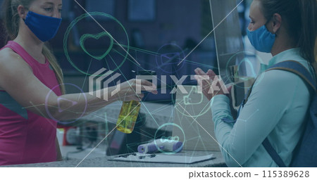 Image of media icons over caucasian female worker with face mask disinfecting hands 115389628
