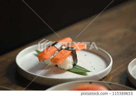 Crab stick Nigiri Sushi serving on white plate. Japanese food concept Crab stick Nigiri Sushi serving on white plate. Japanese food concept 115389653