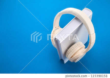 Audio book concept , white book with headphones hanging on 115390158