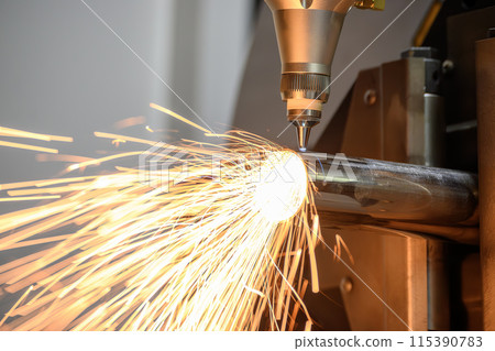 Close up scene the fiber laser cutting machine cut the stainless steel tube and sparkling light. 115390783