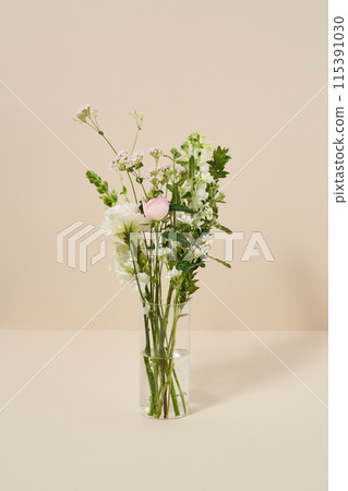 Flowers full of greenery in clear glass bottles 115391030