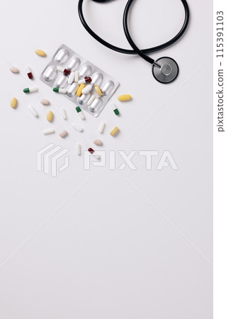 stethoscope and scattered pills 115391103