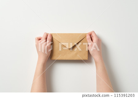 holding the envelope with both hands 115391203