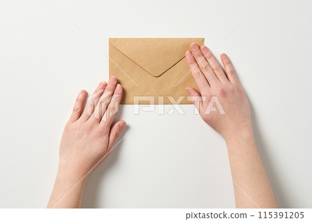 holding the envelope with both hands holding the envelope with both hands 115391205