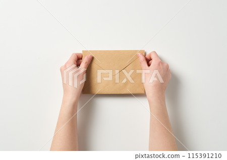 holding the envelope with both hands holding the envelope with both hands 115391210