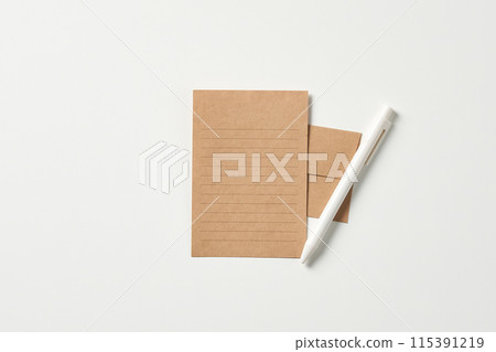 a paper letter paper and a white pen 115391219