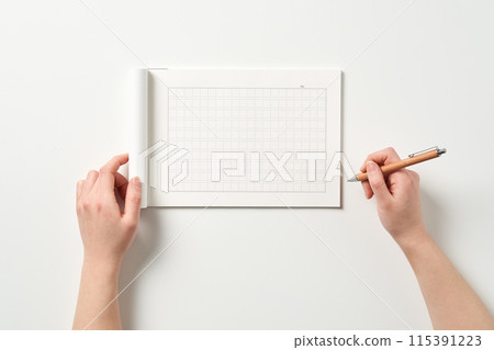 a hand to write on a manuscript 115391223