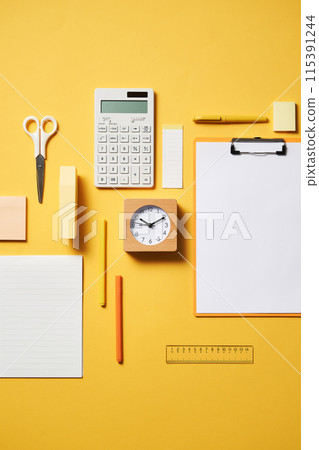 clipboards and office supplies on a yellow background clipboards and office supplies on a yellow background 115391244