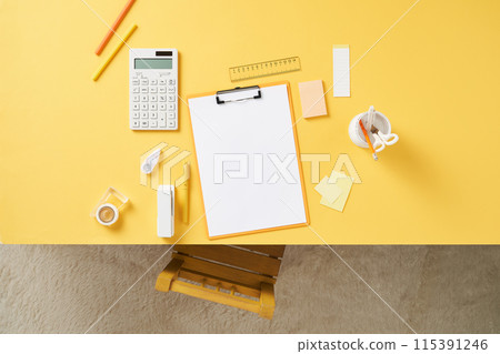 clipboards and office supplies on a yellow desk clipboards and office supplies on a yellow desk 115391246