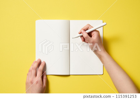 an open notebook against a yellow background 115391253