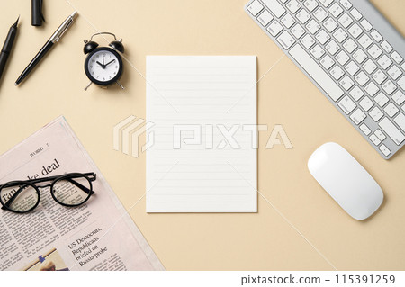 Letter paper and keyboard with light yellow pastel background 115391259