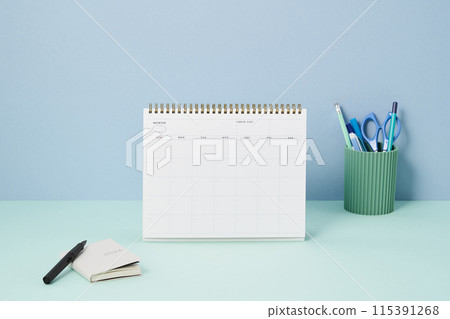 a tabletop and pencil holder on a light green desk 115391268