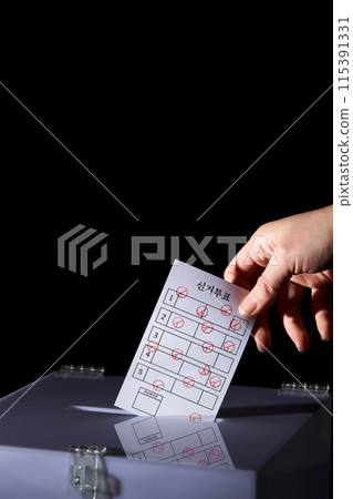 a hand that puts multiple ballots in the ballot box 115391331