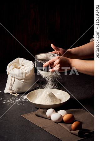 The process of sifting flour with both hands 115391402