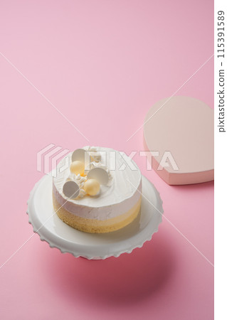 a white cake on a cake stand 115391589