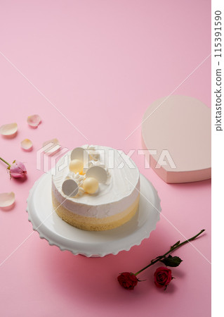 a white cake on a cake stand 115391590