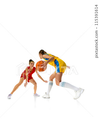 Vertical image of dynamic young women, basketball players in motion, training before match isolated on white studio background Vertical image of dynamic young women, basketball players in motion, training before match isolated on white studio background 115391614