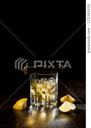 the composition of a glass of lemon wine and a cigar 115391626