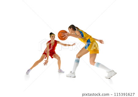 Concentration on victory, Two young women, basketball payers in motion with ball, competing isolated on white studio background Concentration on victory, Two young women, basketball payers in motion with ball, competing isolated on white studio background 115391627