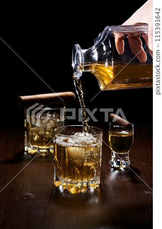 filling a glass with alcohol filling a glass with alcohol 115391642