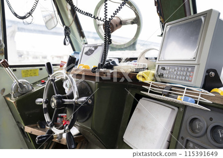 Young woman steering a boat Young woman steering a boat 115391649