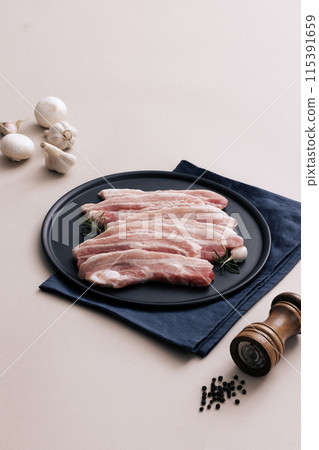 fresh pork belly piled on wooden chopping boards 115391659
