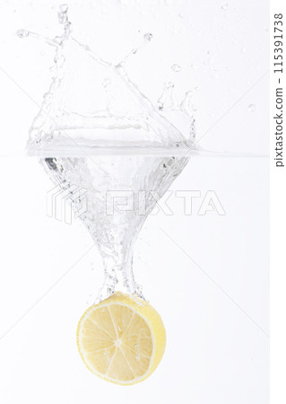 half of a lemon falling into the water half of a lemon falling into the water 115391738