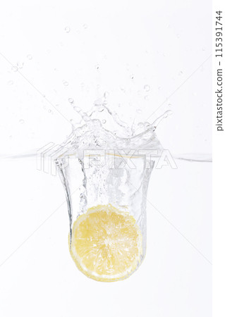 half of a lemon falling into the water 115391744