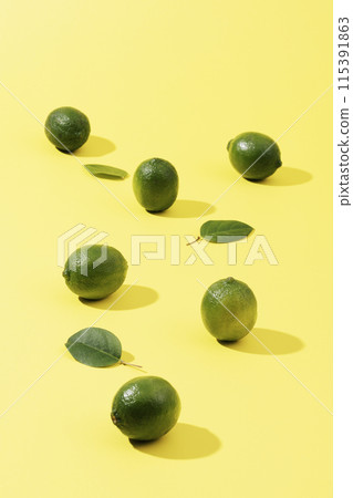 Green lime with a yellow background Green lime with a yellow background 115391863