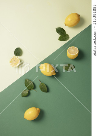 yellow lemon and green leaves on two green tone backgrounds yellow lemon and green leaves on two green tone backgrounds 115391883