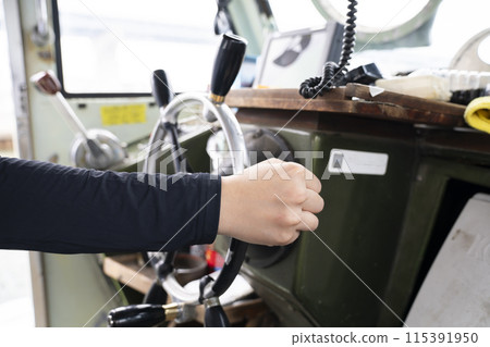 Young woman steering a boat 115391950