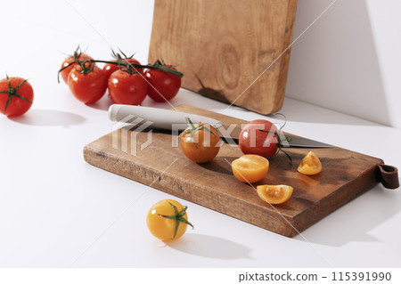 Fresh cherry tomatoes on wood chopping board 115391990